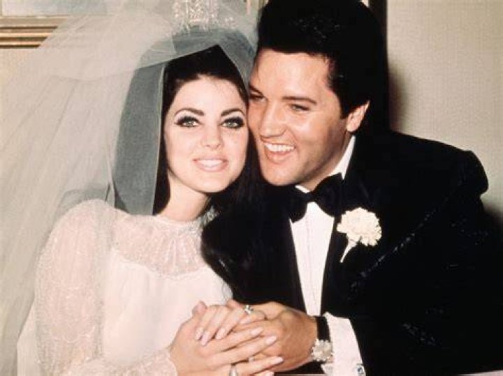 Elvis Presley sits cheek to cheek wit his bride, the former Priscilla Ann Beaulieu, following their wedding
