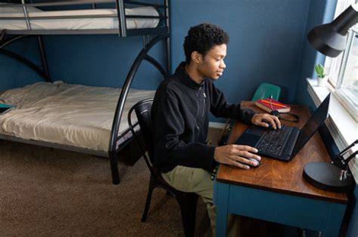 Student studying in dorm room - stock photo